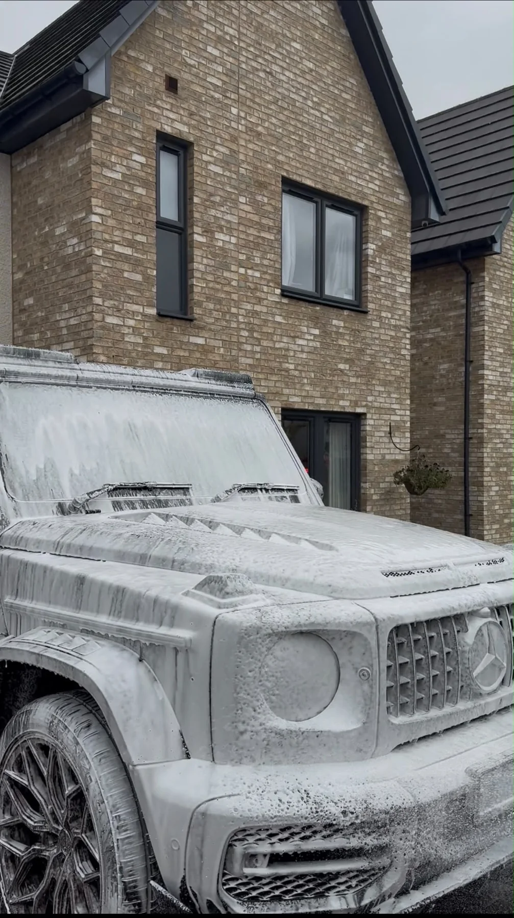 Vehicle covered in snow foam during mobile detailing